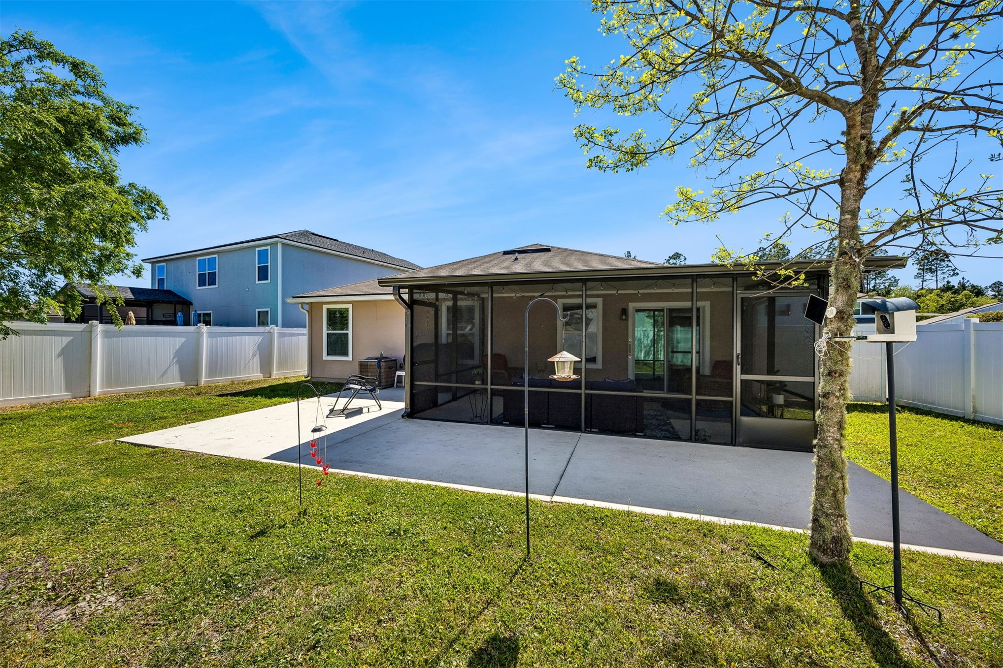 95159 Timberlake Drive Fernandina Beach, FL 32034 - Photo 26 of 33 a view of a house with a backyard and a tree