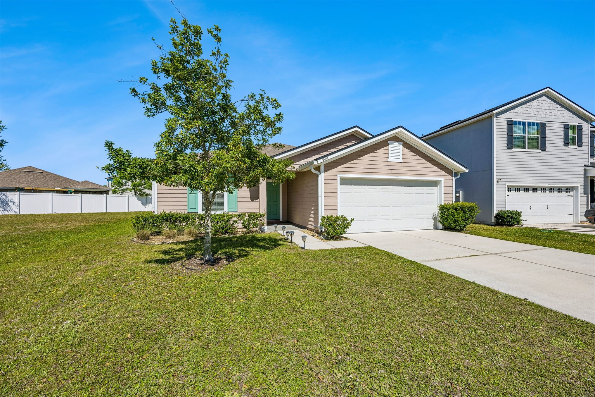 95159 Timberlake Drive Fernandina Beach, FL 32034 - Photo 3 of 33 a front view of a house with a yard