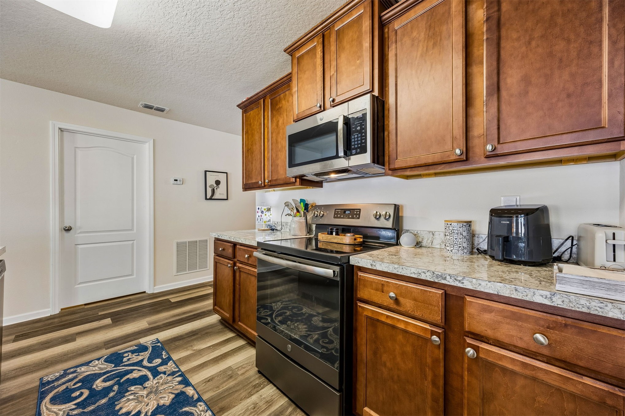 95159 Timberlake Drive Fernandina Beach, FL 32034 - Photo 6 of 33 a kitchen with stainless steel appliances granite countertop a sink stove and microwave