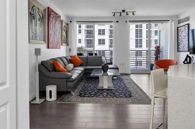 a living room with furniture and wooden floor