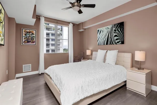 a view of a room that has a bed and a window