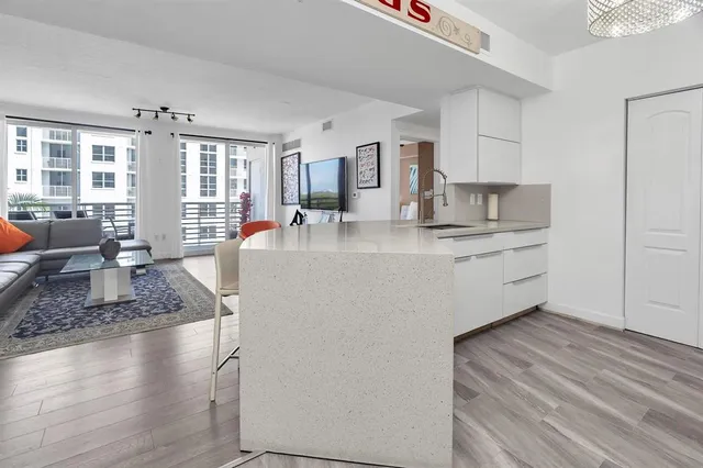 a large kitchen with stainless steel appliances granite countertop a granite counter tops a window and a counter space