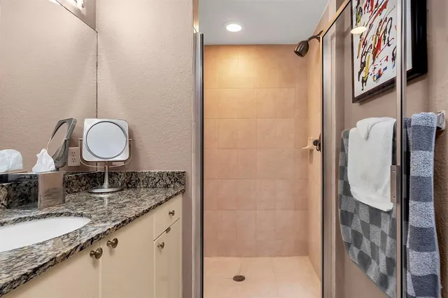 a living room with furniture kitchen view and a wooden floor