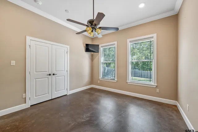 a view of a livingroom with a ceiling fan and window