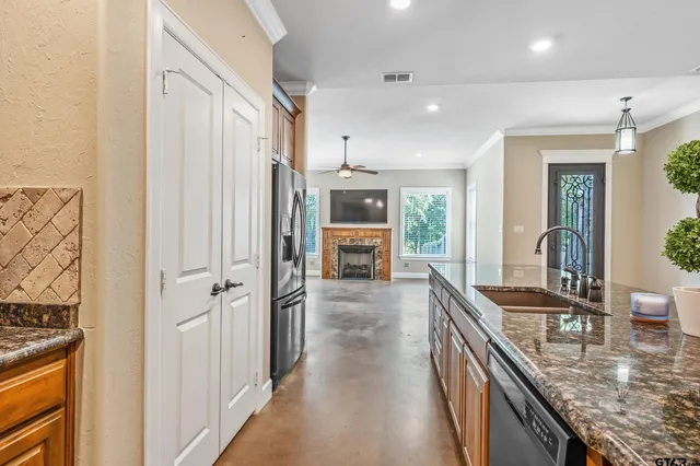 a view of a livingroom with a ceiling fan window and a fireplace