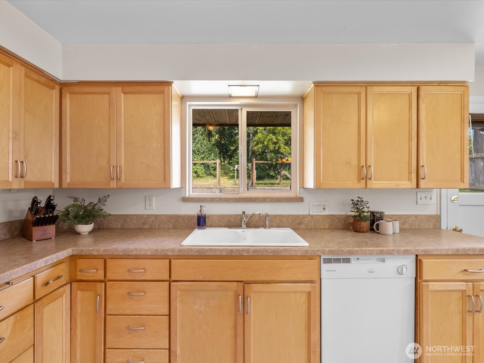 4913 West View Drive Everett, WA 98203 - Photo 13 of 37 a kitchen with sink a window and cabinets