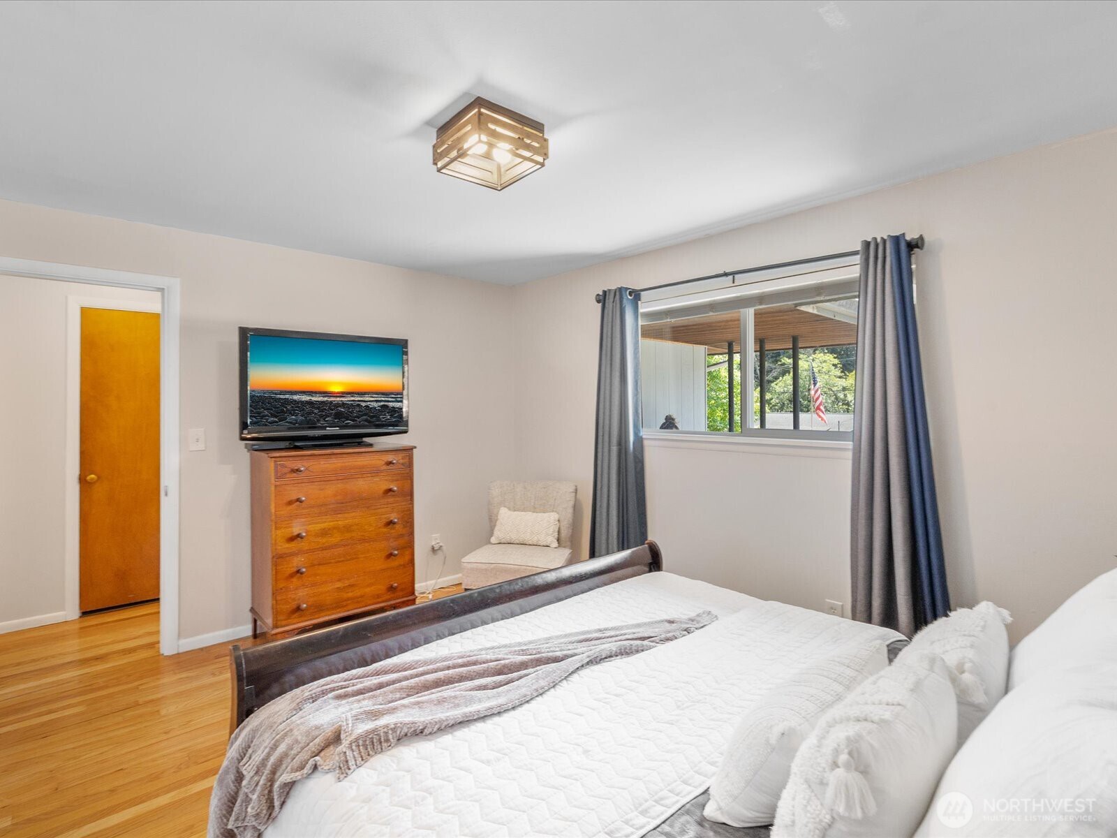 4913 West View Drive Everett, WA 98203 - Photo 15 of 37 a bedroom with a bed and a chandelier