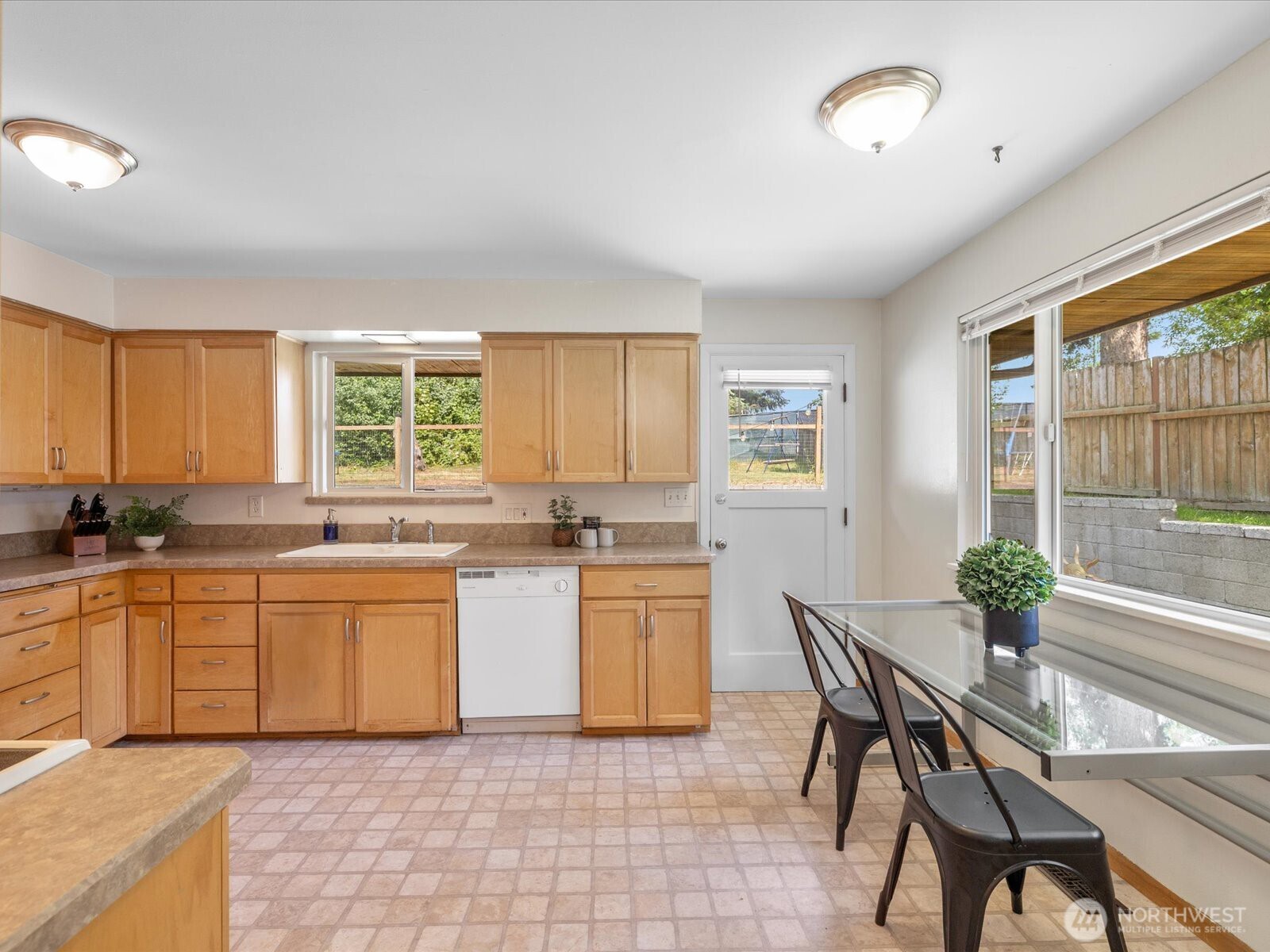 4913 West View Drive Everett, WA 98203 - Photo 10 of 37 a kitchen with a sink dining table and chairs
