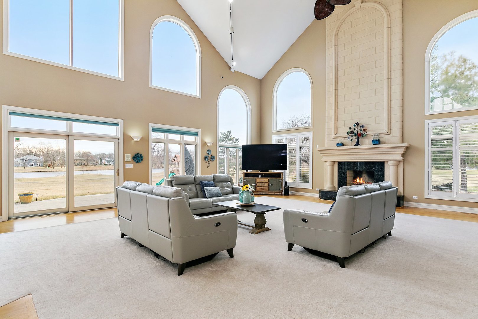 741 Braintree Lane Bartlett, IL 60103 - Photo 16 of 80 a living room with furniture a flat screen tv and a fireplace