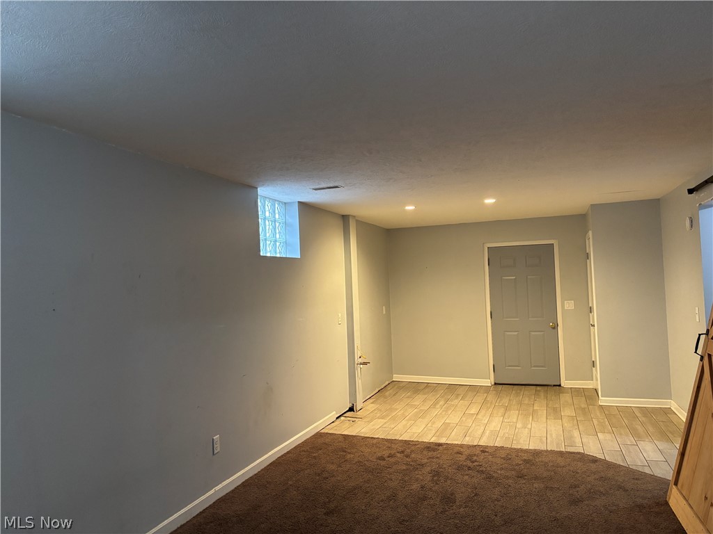 4301 Steubenville Road Southeast Amsterdam, OH 43903 - Photo 17 of 27 Partially finished, carpet and tile flooring