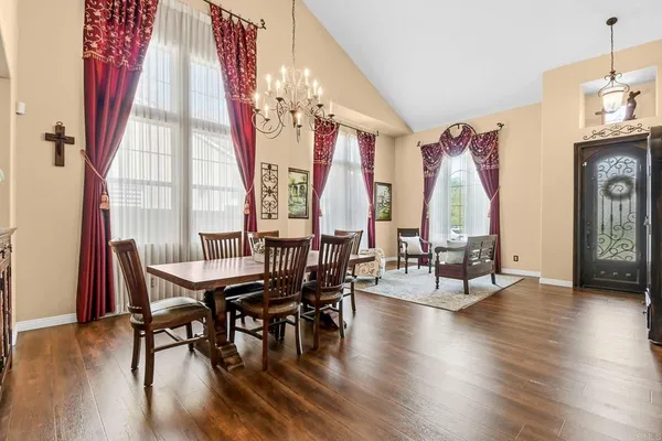 a view of a dining room with furniture and wooden floor