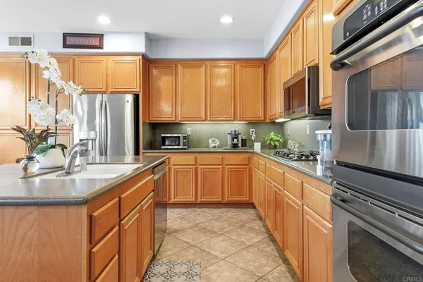 a kitchen with stainless steel appliances granite countertop a refrigerator sink and cabinets