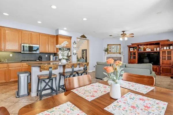 a living room with stainless steel appliances kitchen island granite countertop a rug kitchen view and living room view