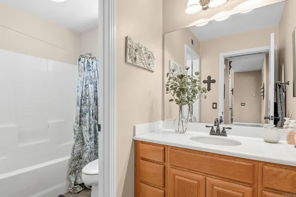 a bathroom with a double vanity sink mirror and shower