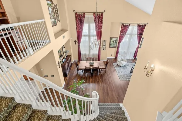 a view of stairs with furniture and wooden floor