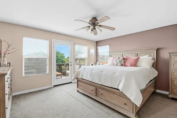 a spacious bedroom with a bed and a chandelier