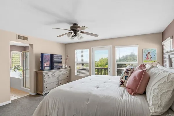 a bedroom with a large bed and a tv