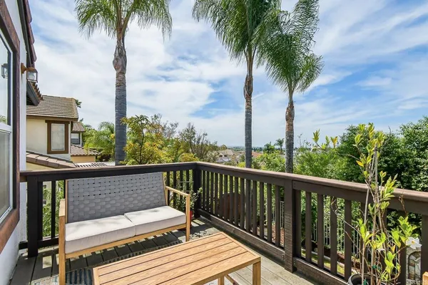 a view of balcony with wooden floor and outdoor seating