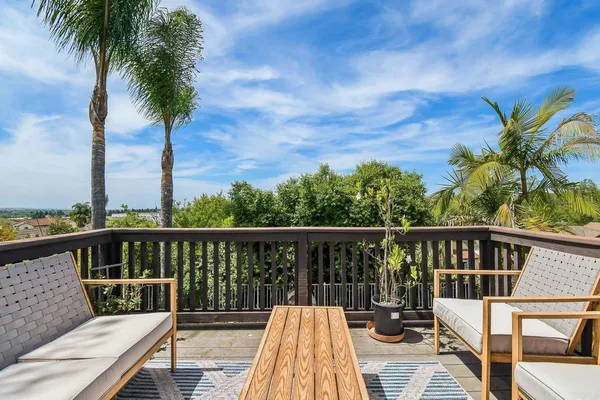 a view of balcony with wooden floor and outdoor seating