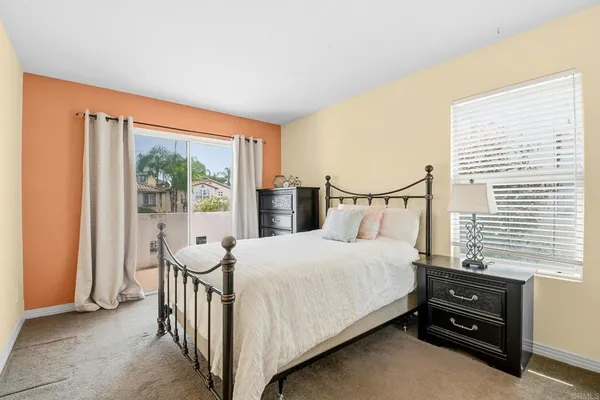 a bedroom with a bed and a large window