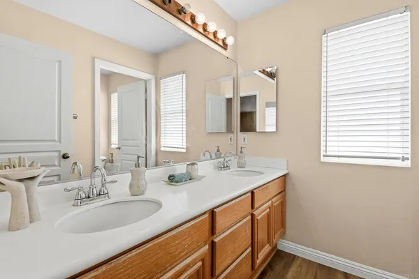 a bathroom with a double vanity sink and a mirror