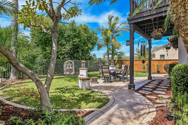 a view of a chairs and table in backyard of the house