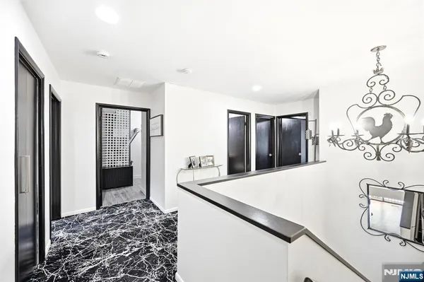 a living room with stainless steel appliances furniture a rug and a large window