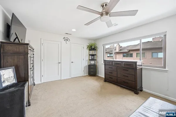 a view of a hallway with closet and cabinet