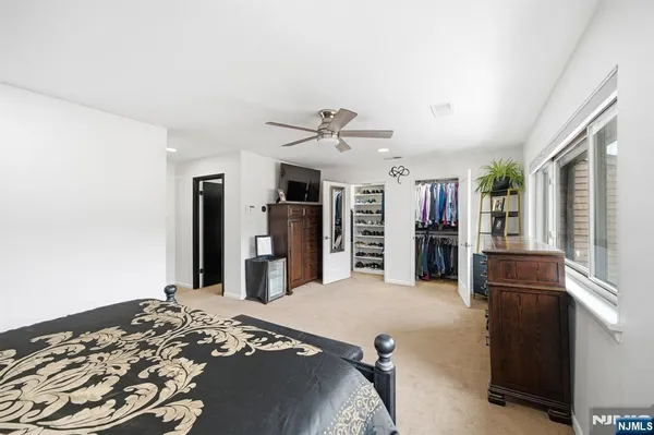 a bedroom with a bed and a television