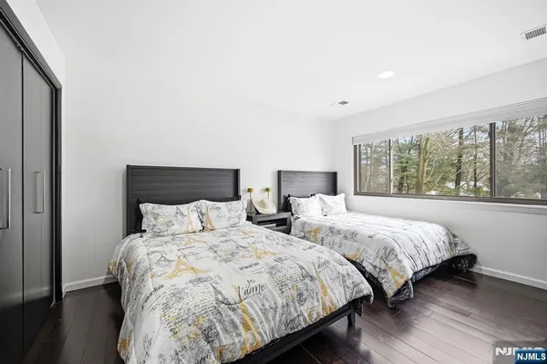 a bedroom with two beds and a large window