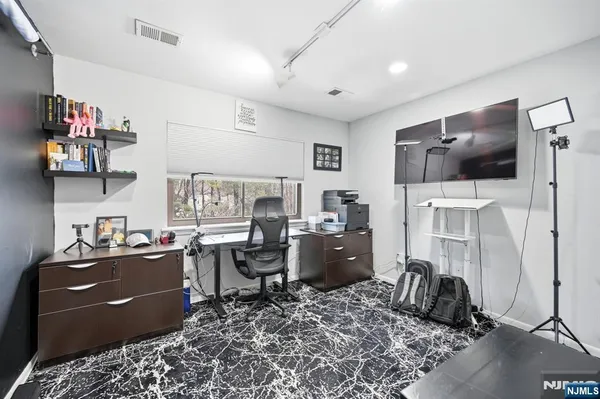 a view of a workspace with furniture and a flat screen tv