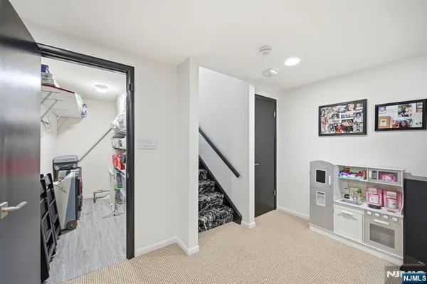 a view of a hallway with furniture and entryway