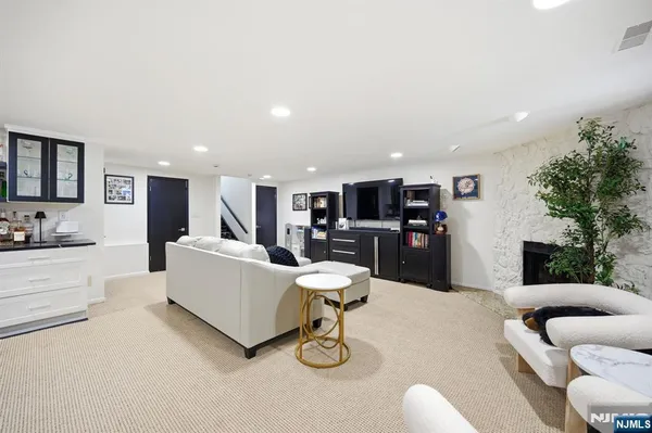 a living room with furniture and kitchen view