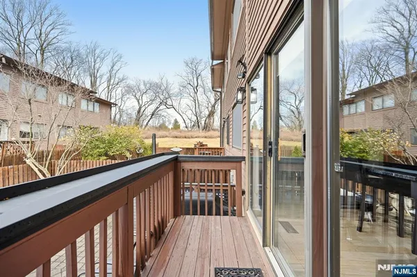 a view of balcony with wooden floor and fence