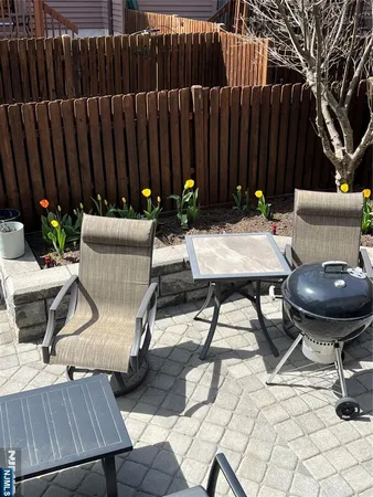 a view of a chairs and tables in the back yard of the house