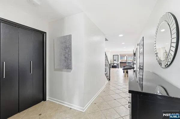 a hallway with dining area and chandelier