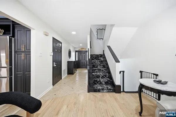 a view of entryway with livingroom and wooden floor