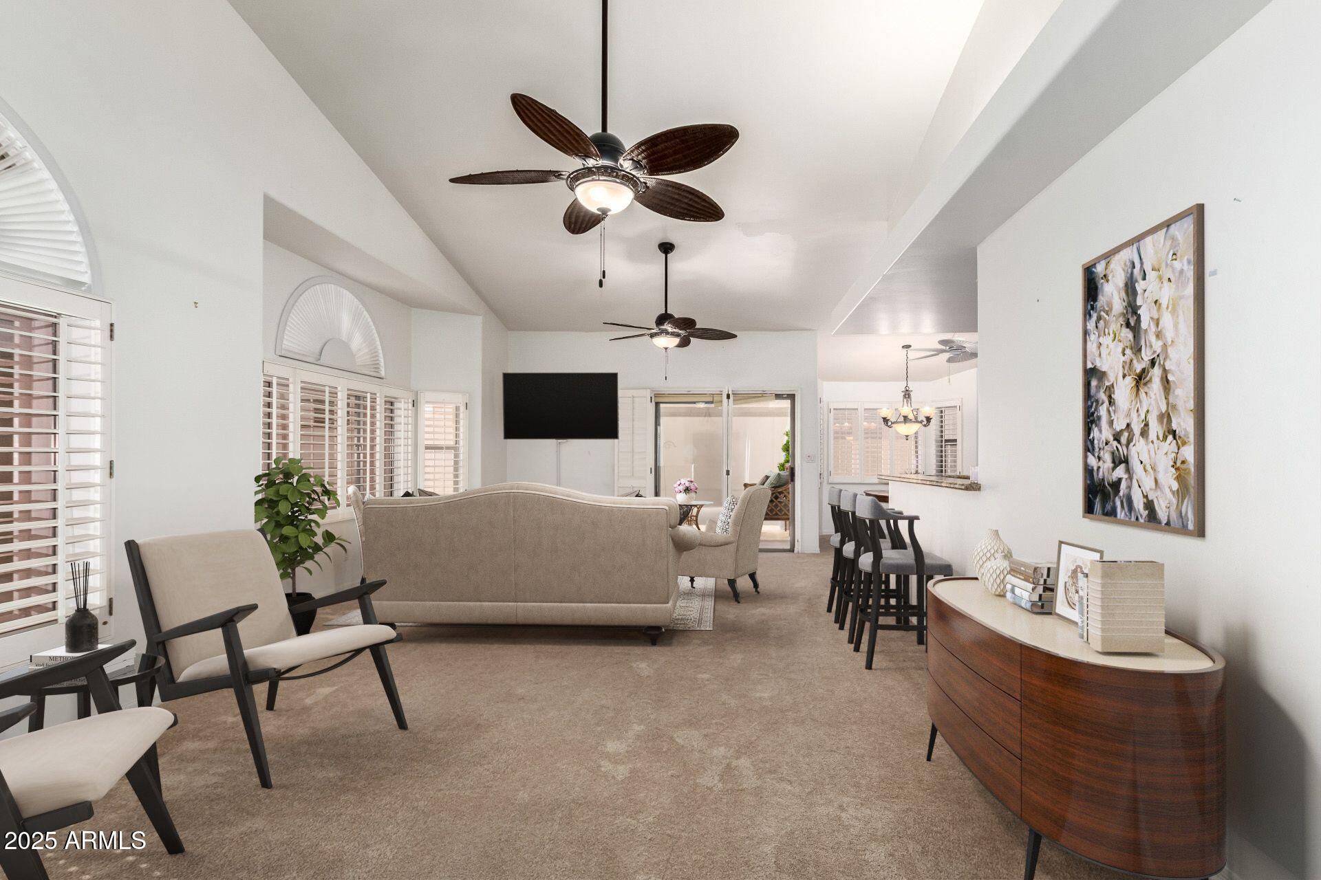 5830 East McKellips Road, Unit 100 Mesa, AZ 85215 - Photo 12 of 48 a living room with furniture and a chandelier