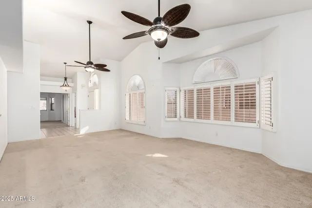 a bedroom with furniture and a large window