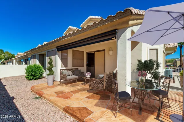 a view of a house with wooden fence