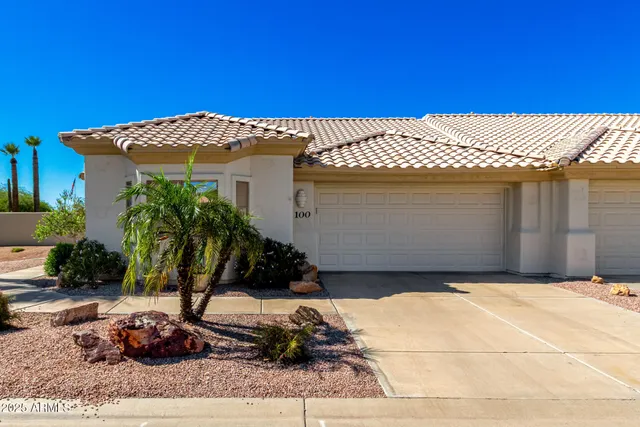 a view of a house with a swimming pool and sitting area