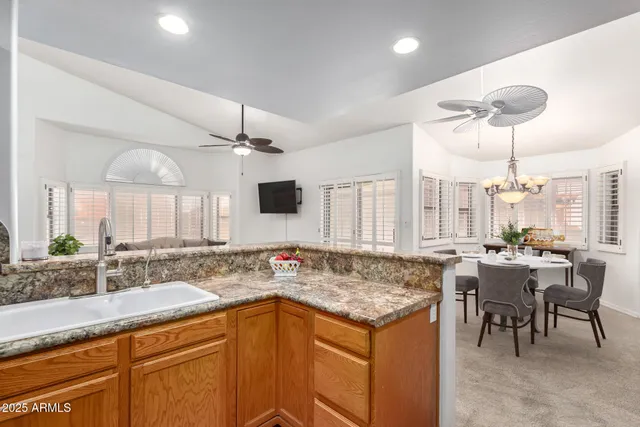 a kitchen with stainless steel appliances granite countertop a sink stove and cabinets