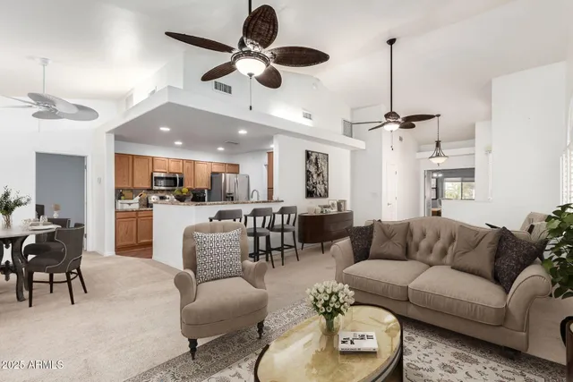 an empty room with windows and ceiling fan
