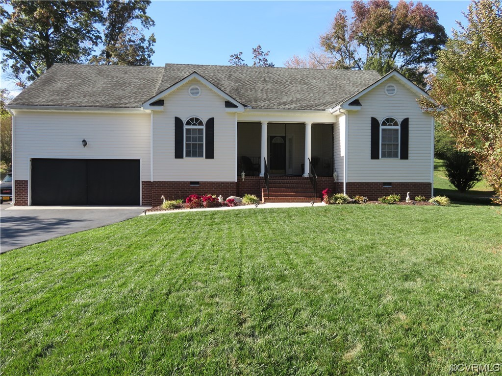 a front view of a house with a garden and yard