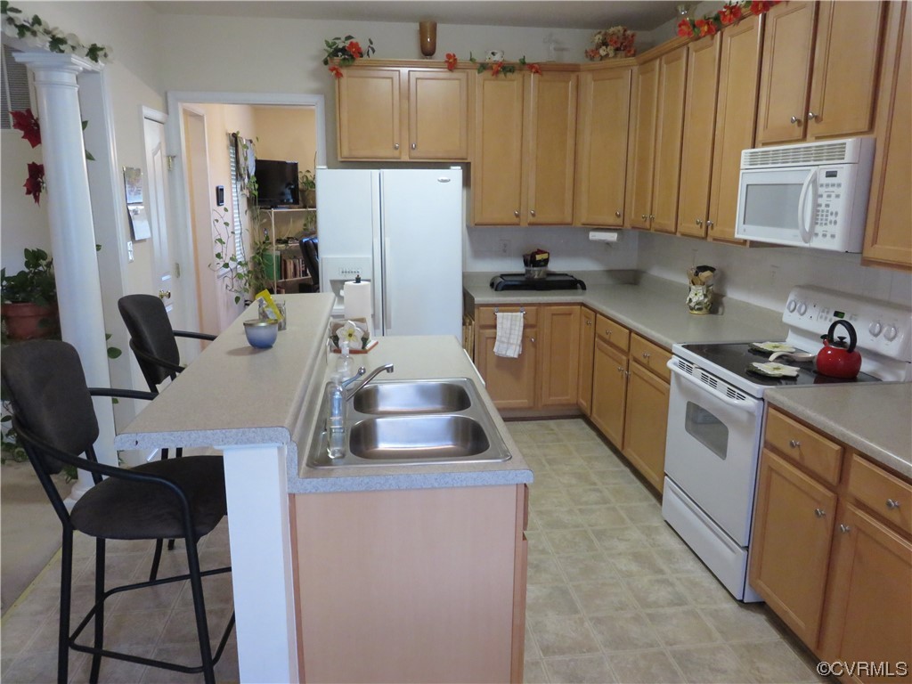 4740 Southmoor Road Richmond, VA 23234 - Photo 24 of 42 a kitchen with a refrigerator a stove a sink dishwasher and wooden cabinets