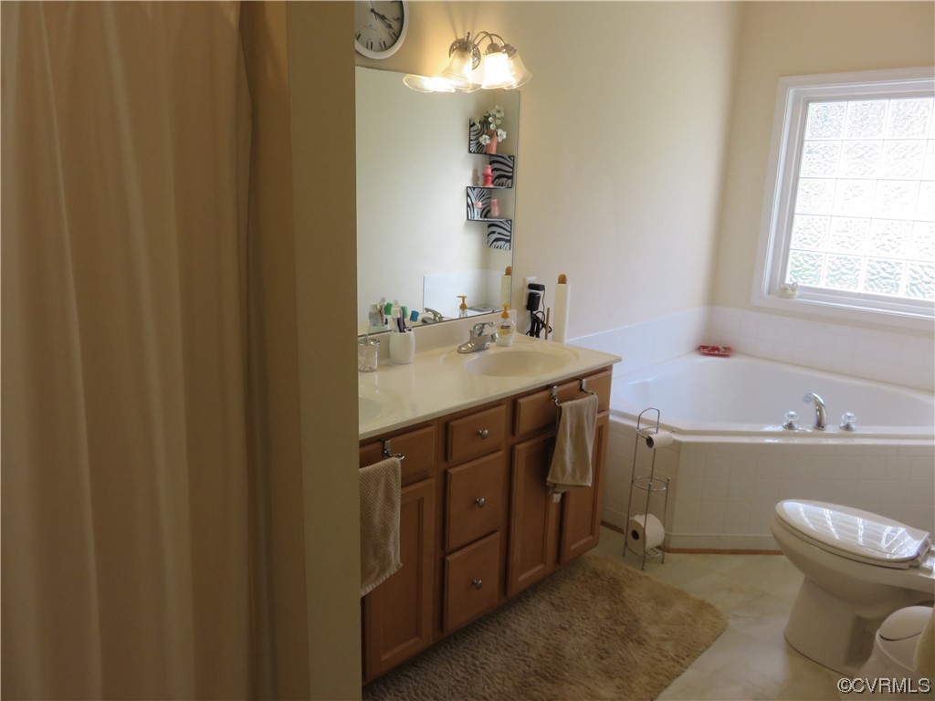 4740 Southmoor Road Richmond, VA 23234 - Photo 29 of 42 a bathroom with a sink a toilet and a mirror