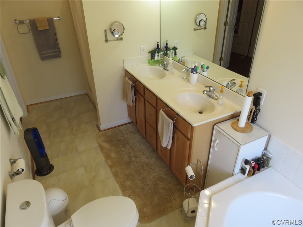 4740 Southmoor Road Richmond, VA 23234 - Photo 30 of 42 a bathroom with a sink mirror and toilet