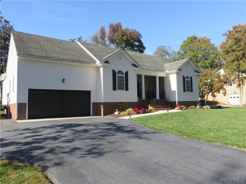 4740 Southmoor Road Richmond, VA 23234 - Photo 3 of 42 a front view of a house with a yard and garage