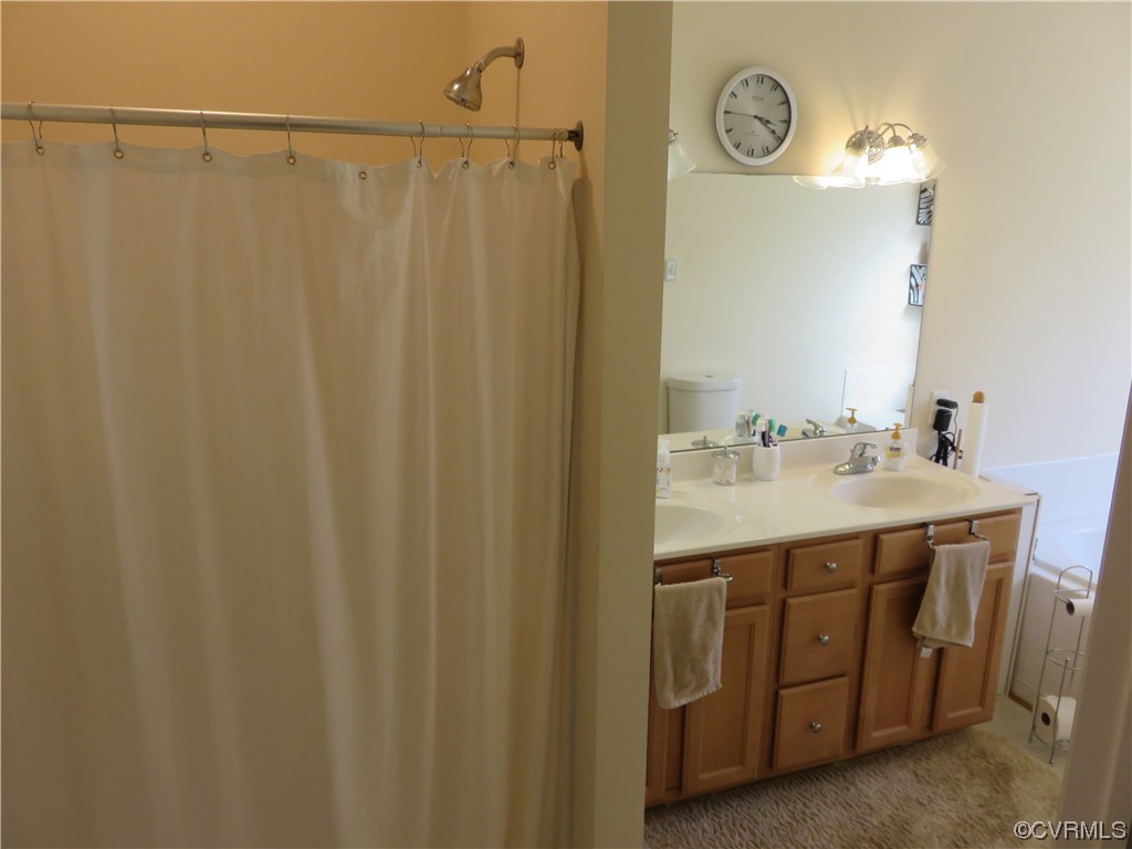 4740 Southmoor Road Richmond, VA 23234 - Photo 31 of 42 a bathroom with a double vanity sink and a mirror