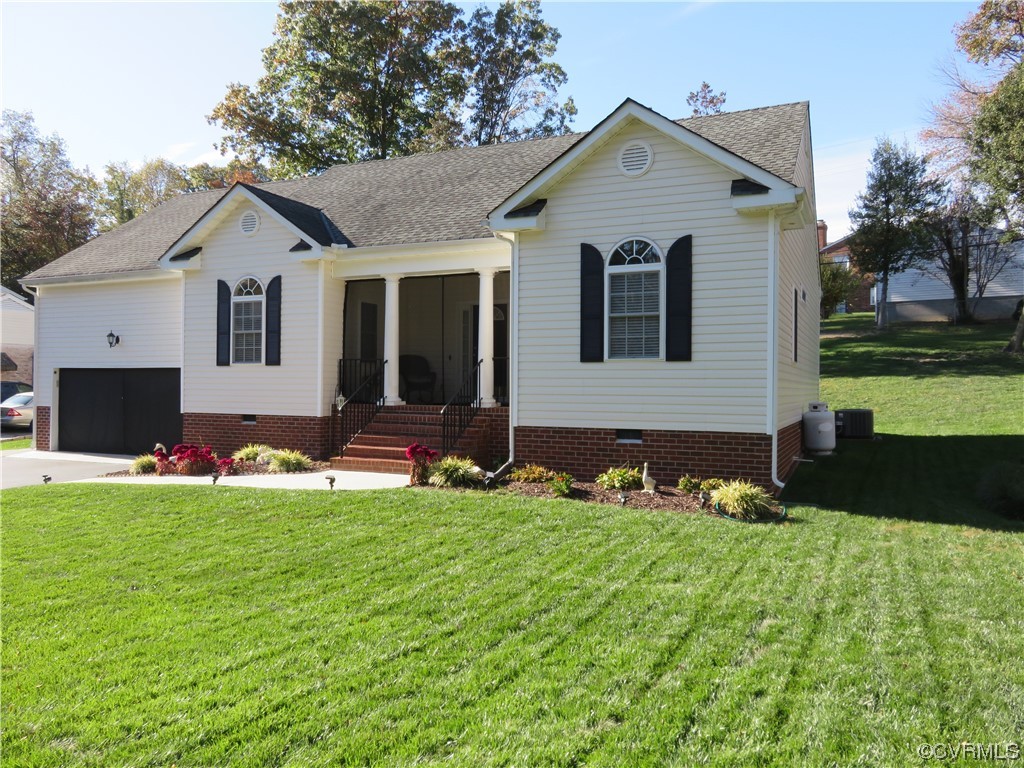 4740 Southmoor Road Richmond, VA 23234 - Photo 4 of 42 a front view of a house with a yard and garage